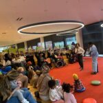 Two authors reading to group of children