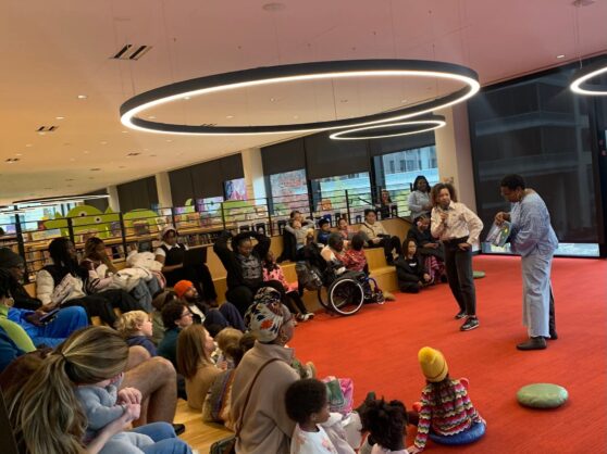 Two authors reading to group of children