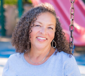Woman sitting on a swing smiling